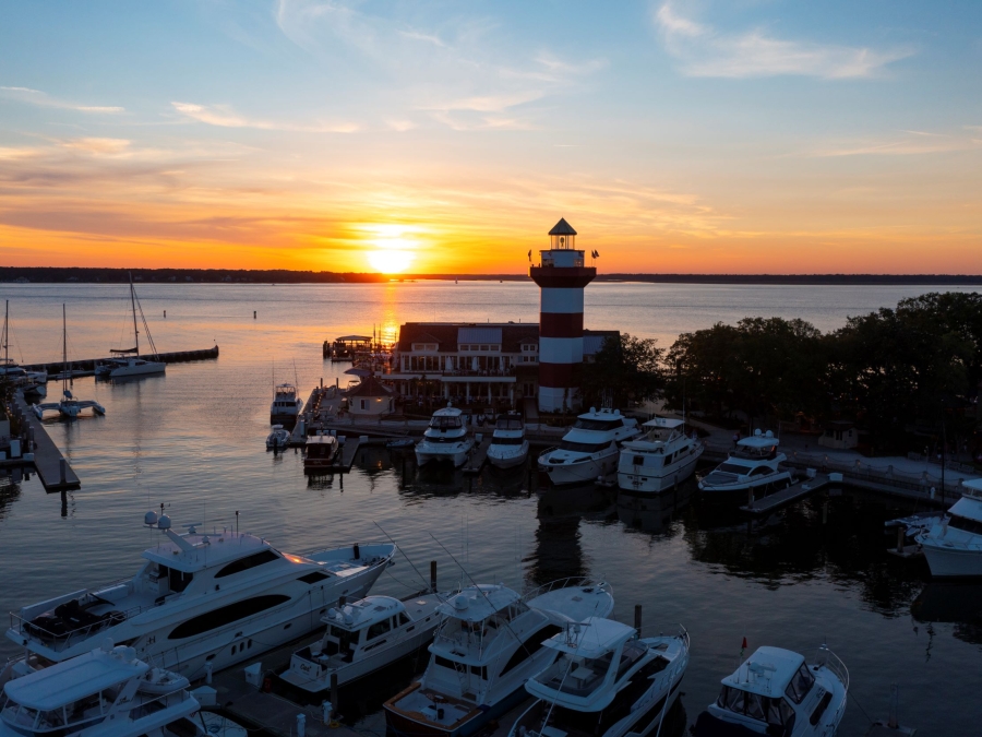 A view of the Quarterdeck restaurant and the Harbour Town Lighthouse in the Harbour Town Yacht Basin at sunset over the Calibogue Sound. 