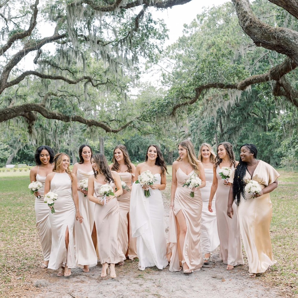 Girls bridal party posing under trees 